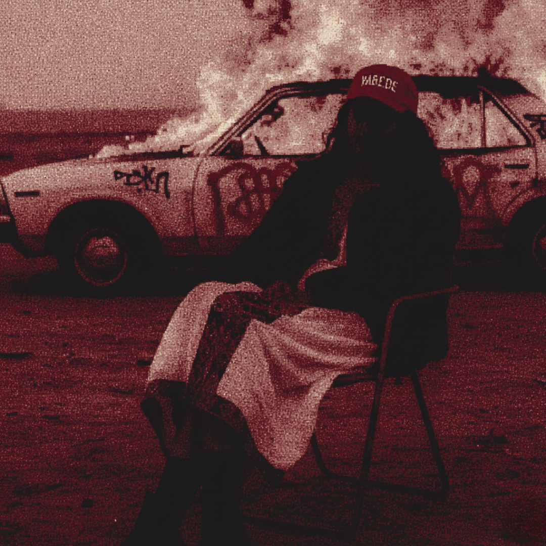 Person sitting in front of a distressed car with a red cap, in a gritty, monochromatic style.